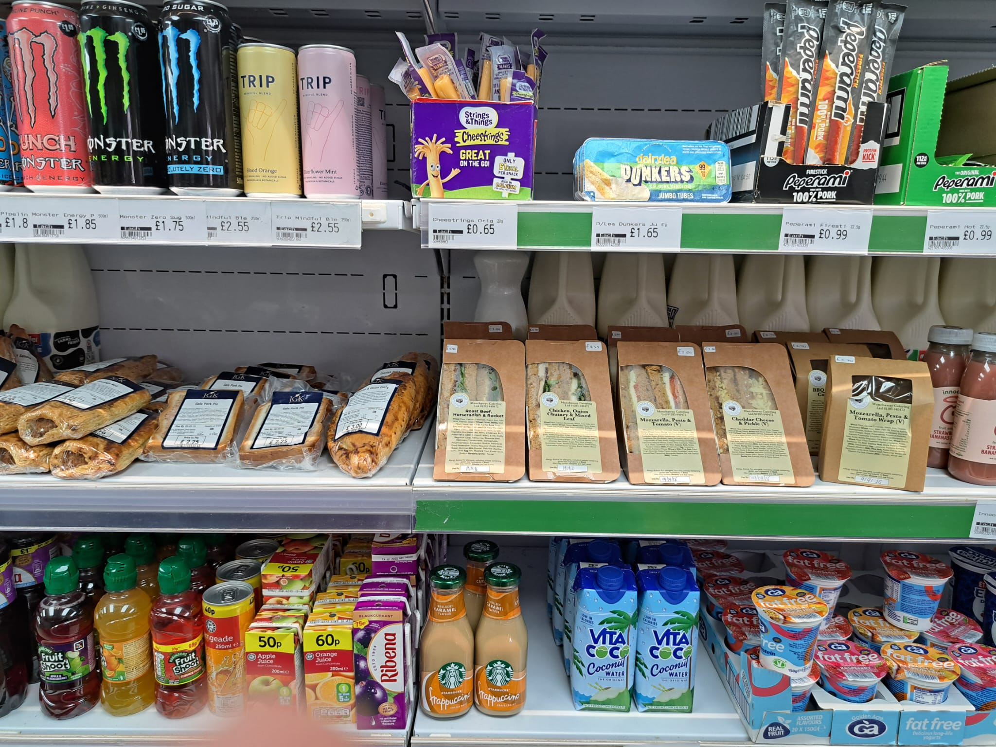 Photograph of the fridge with fresh sandwiches and drinks