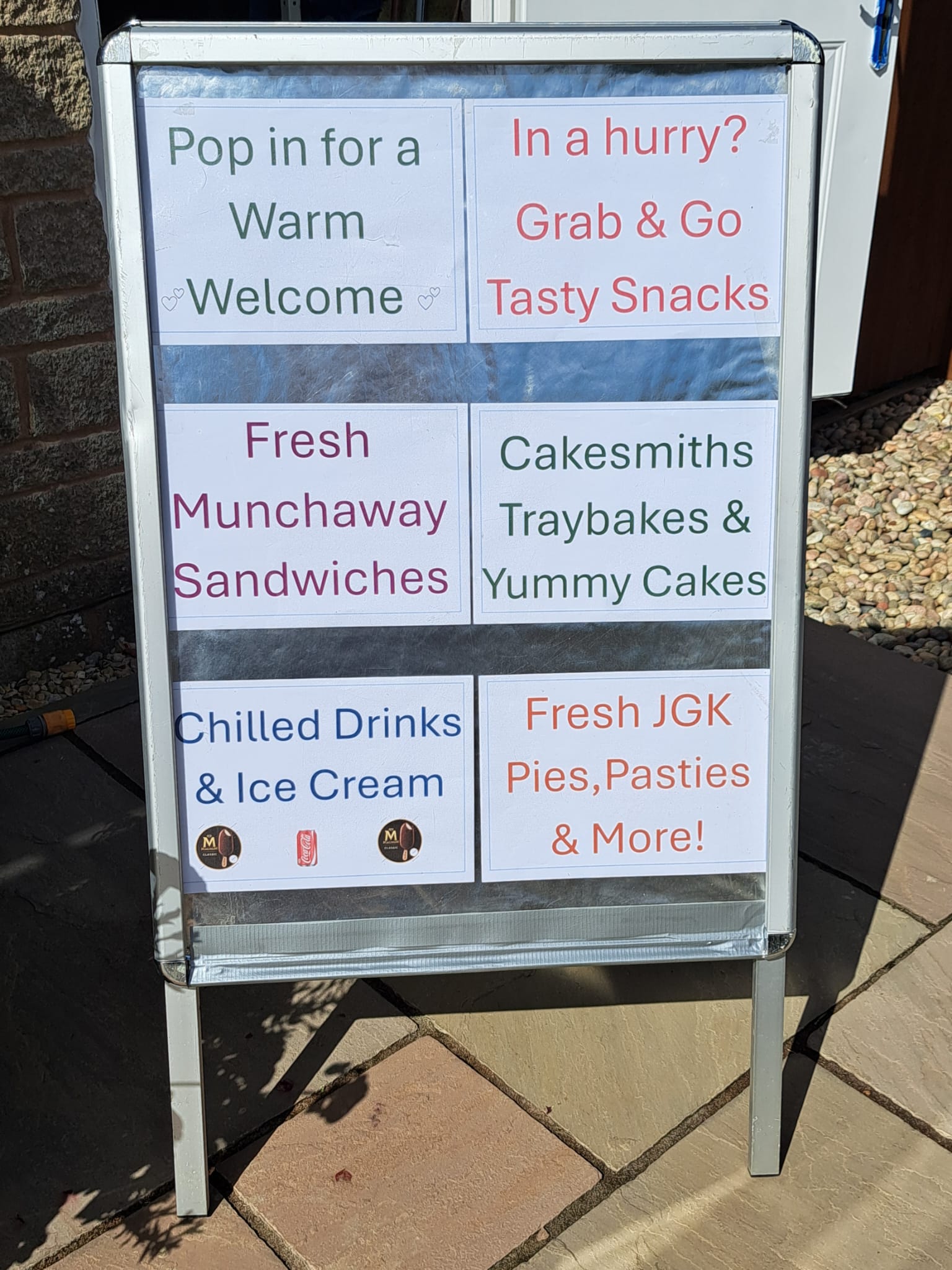 Photograph of the sign outside the shop, listing some of the products available in the shop