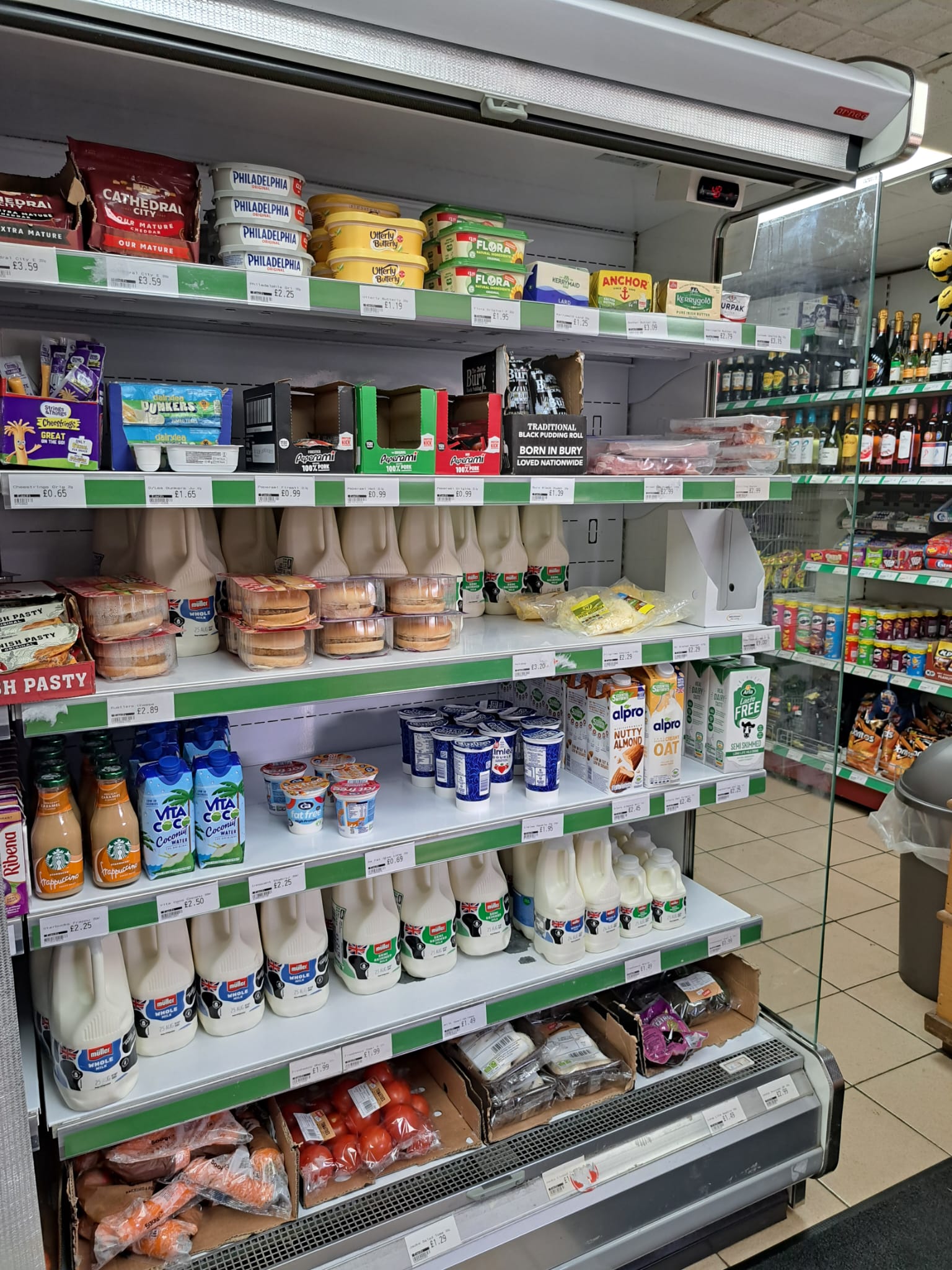 Photograph of the fridge with some of the dairy products available in the shop