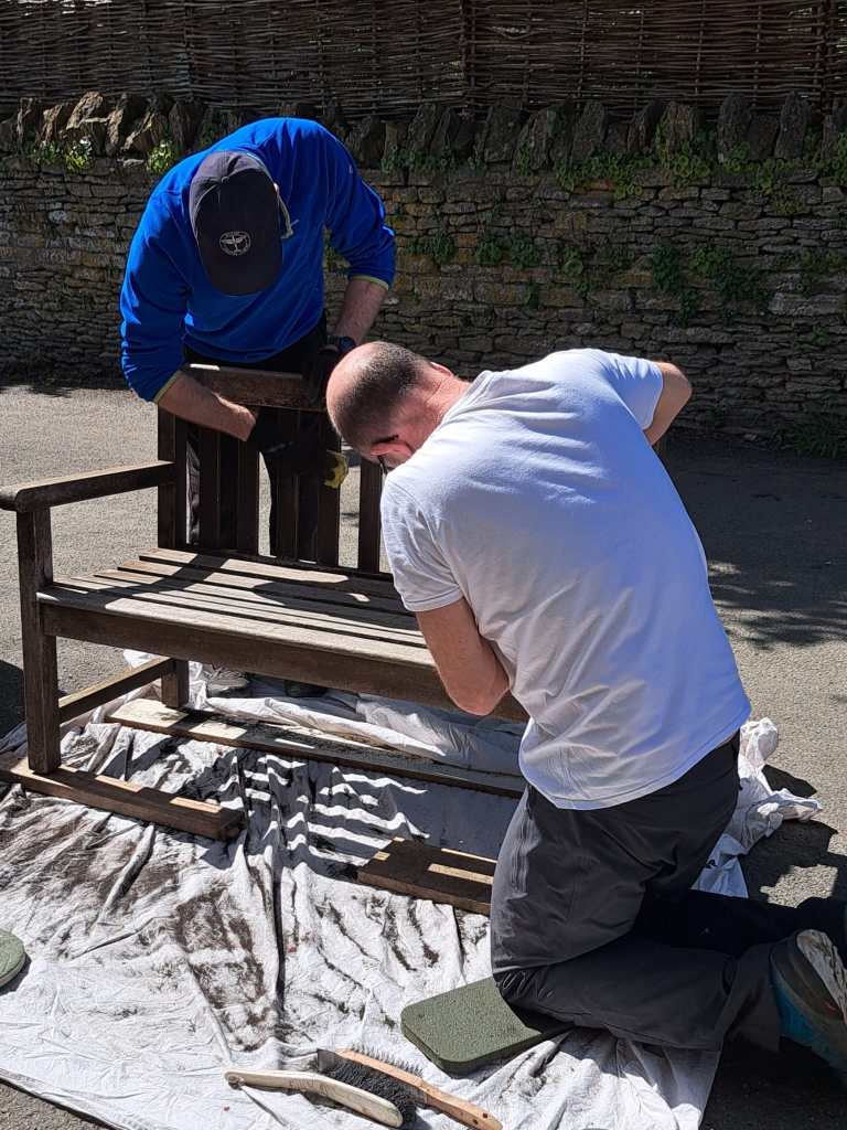 Photograph of volunteers painting a bench