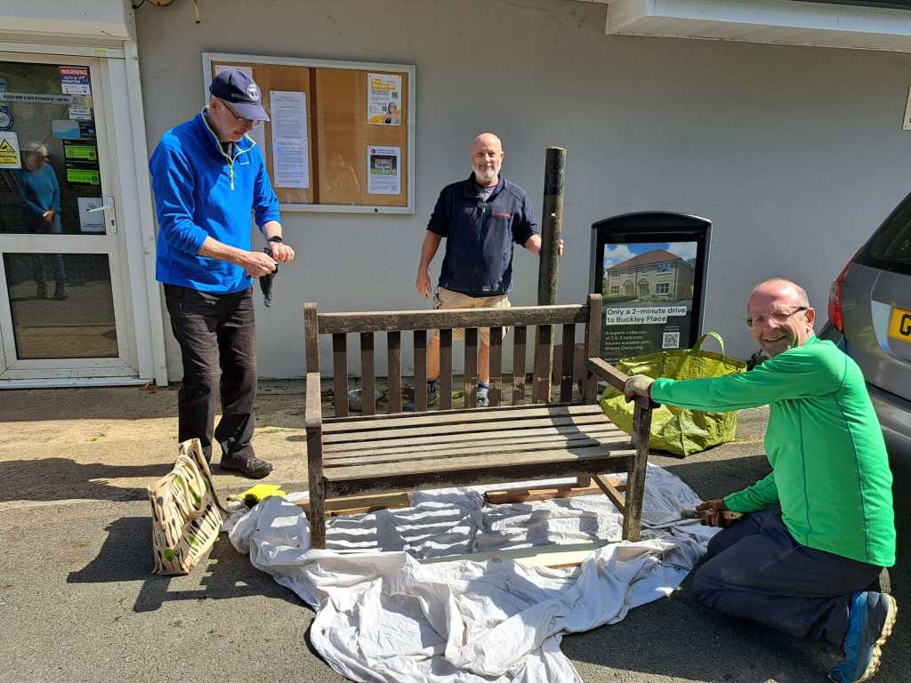 Photograph of volunteers painting a bench